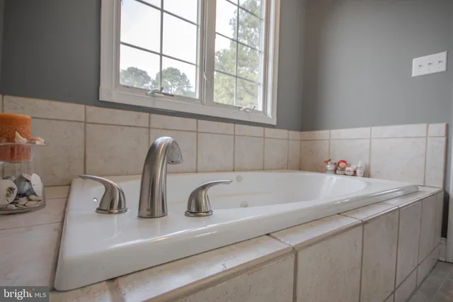 a spacious bedroom with a bed and a chandelier