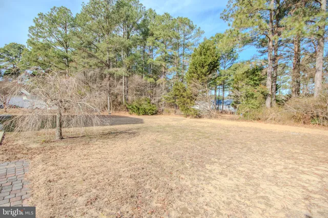 a view of white house with a yard