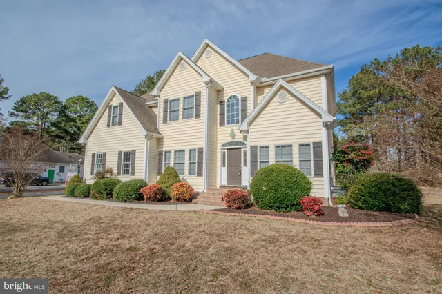 a view of a house with a yard and garage