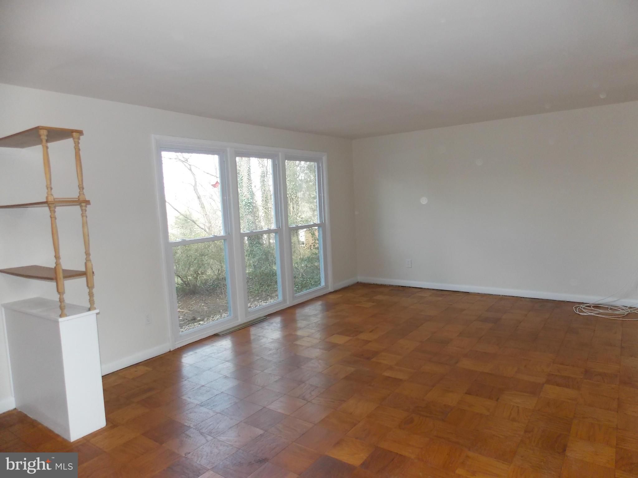 6334 Beryl Road Alexandria, VA 22312 - Photo 8 of 26 a view of an empty room with wooden floor and a window