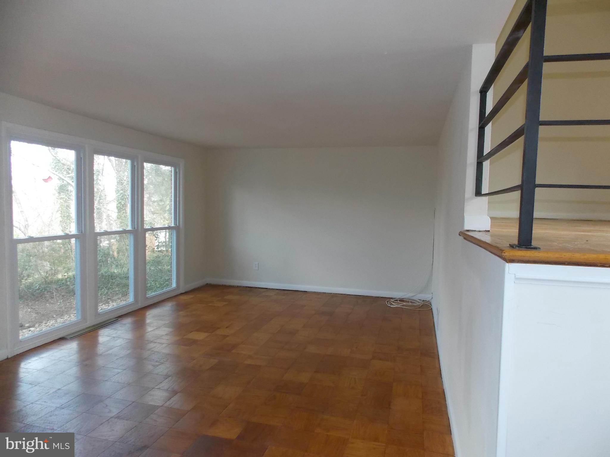 6334 Beryl Road Alexandria, VA 22312 - Photo 10 of 26 wooden floor in an empty room with a window