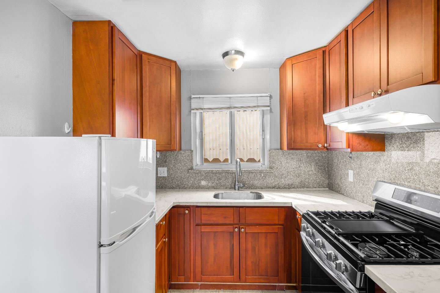353 Cedar Street Millbrae, CA 94030 - Photo 11 of 19 a kitchen with stainless steel appliances granite countertop a refrigerator and a sink