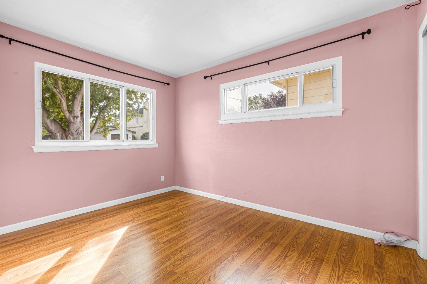 353 Cedar Street Millbrae, CA 94030 - Photo 12 of 19 a view of an empty room with wooden floor and a window