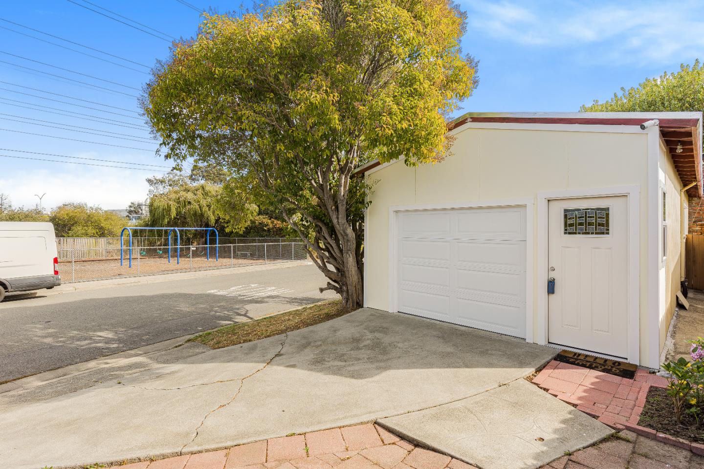 353 Cedar Street Millbrae, CA 94030 - Photo 19 of 19 a view of a white house with a large tree