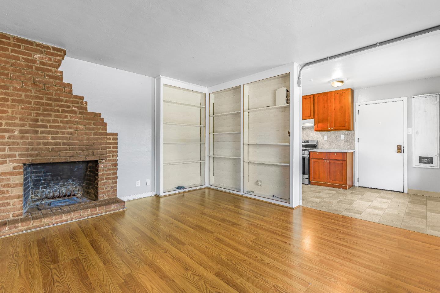 353 Cedar Street Millbrae, CA 94030 - Photo 6 of 19 a view of empty room with wooden floor and fireplace