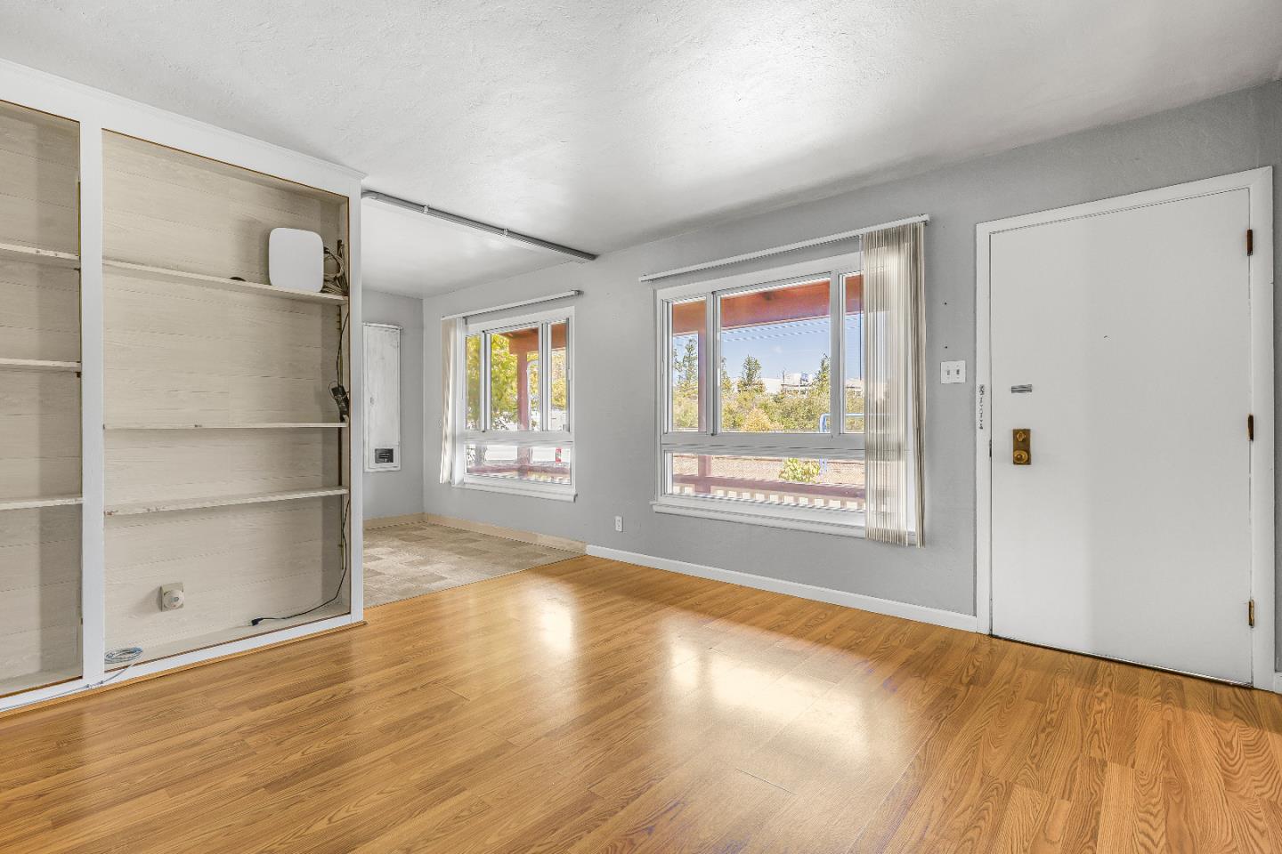 353 Cedar Street Millbrae, CA 94030 - Photo 8 of 19 a view of an empty room with a window and wooden floor