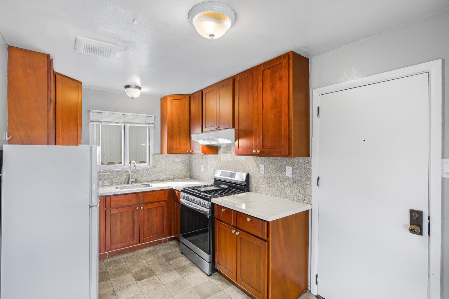 353 Cedar Street Millbrae, CA 94030 - Photo 9 of 19 a kitchen with a sink stove and cabinets