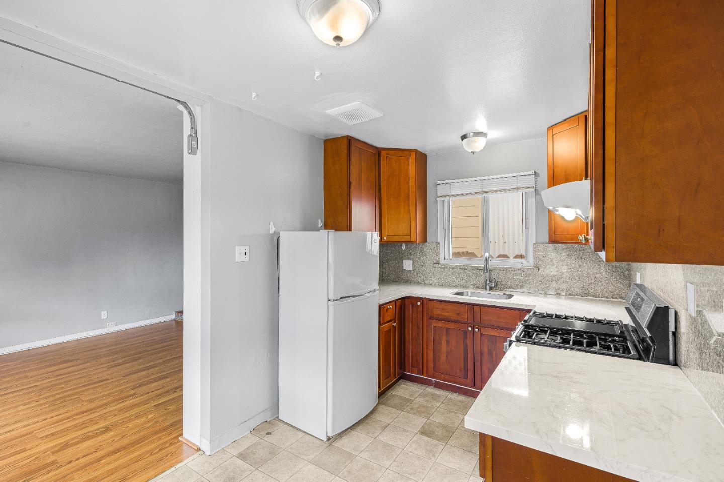 353 Cedar Street Millbrae, CA 94030 - Photo 10 of 19 a kitchen with stainless steel appliances granite countertop a sink stove and refrigerator