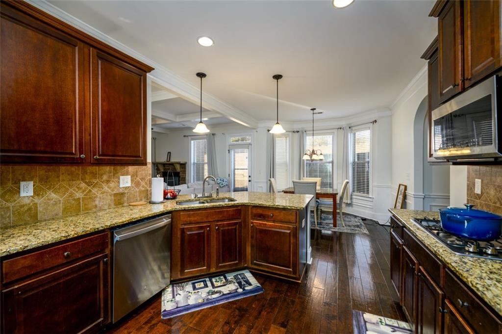 1979 Trinity Mill Drive Dacula, GA 30019 - Photo 11 of 38 a kitchen with lots of counter top space and dining table