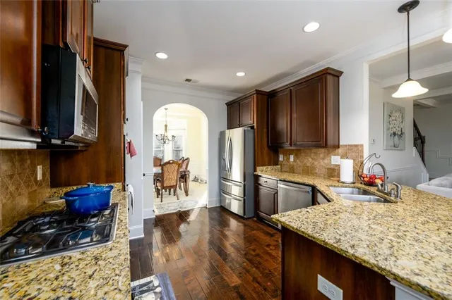 a kitchen with sink refrigerator and microwave