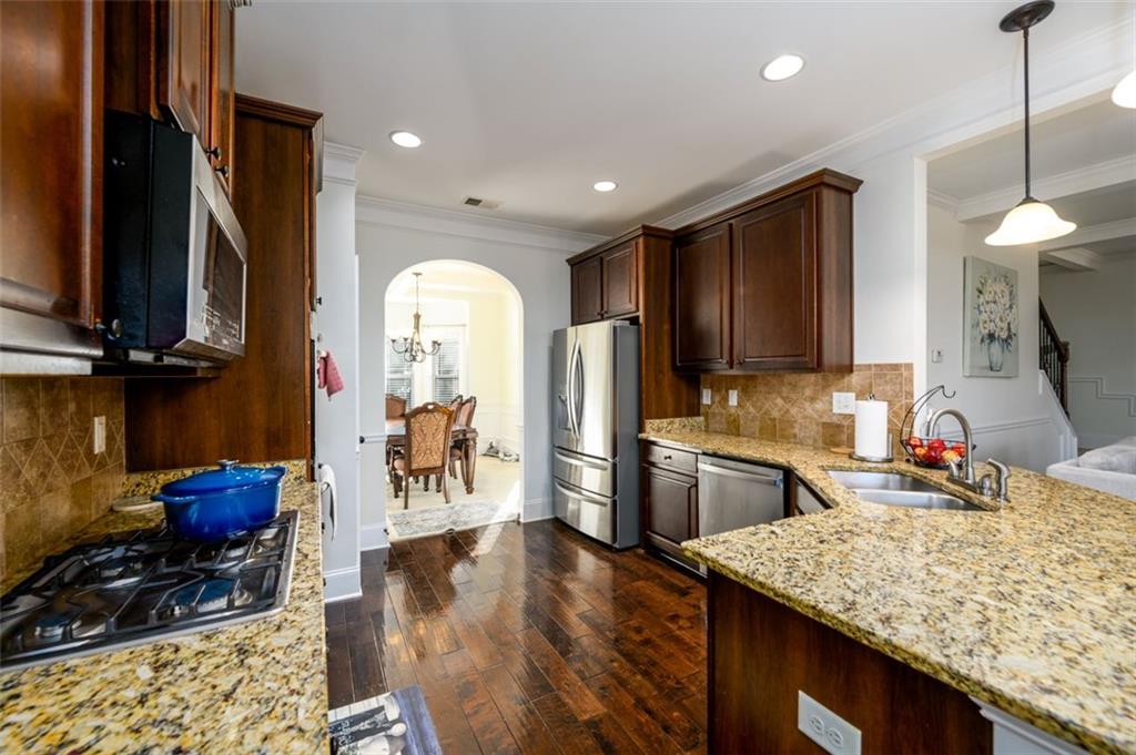 1979 Trinity Mill Drive Dacula, GA 30019 - Photo 13 of 38 a kitchen with sink refrigerator and microwave