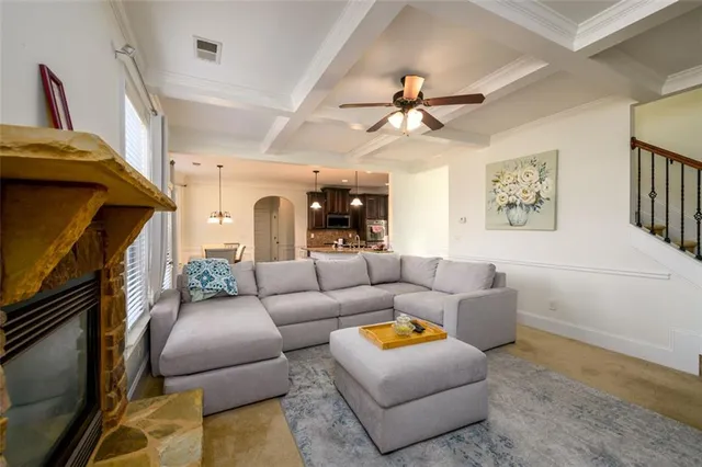 a living room with furniture ceiling fan and a rug