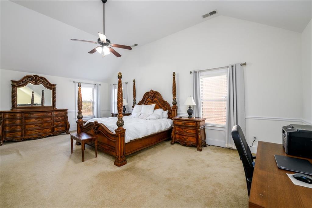 1979 Trinity Mill Drive Dacula, GA 30019 - Photo 20 of 38 a bedroom with a bed and a chandelier