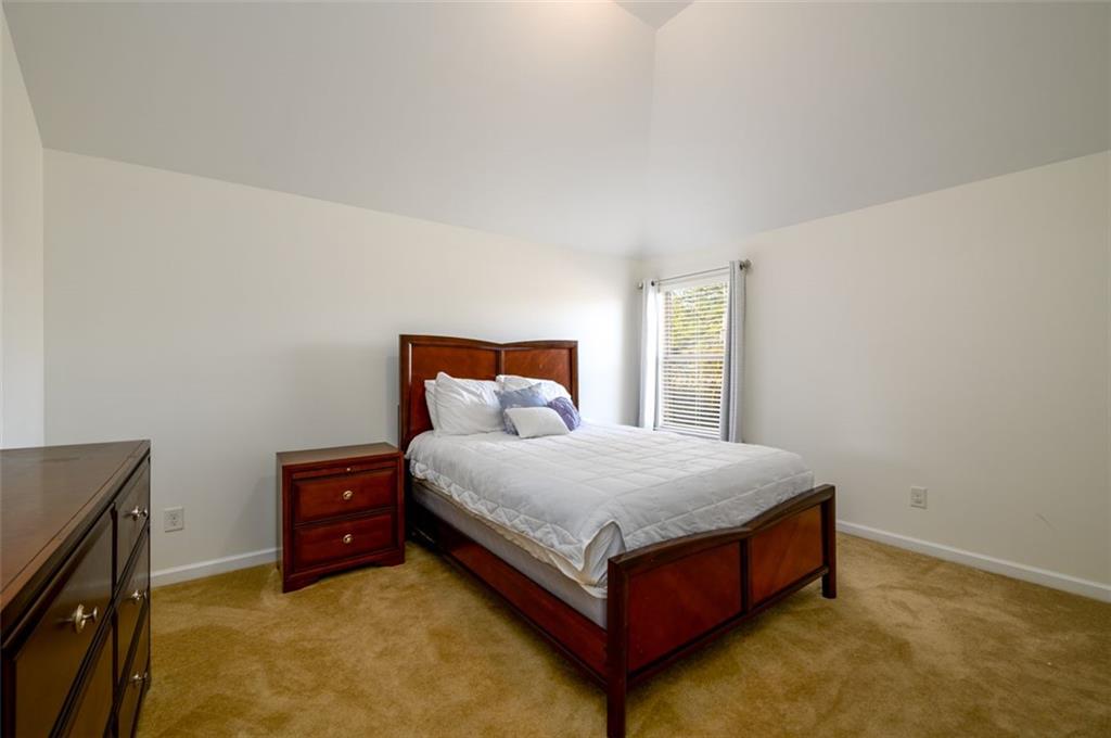 1979 Trinity Mill Drive Dacula, GA 30019 - Photo 27 of 38 a bed sitting in a bedroom next to a window