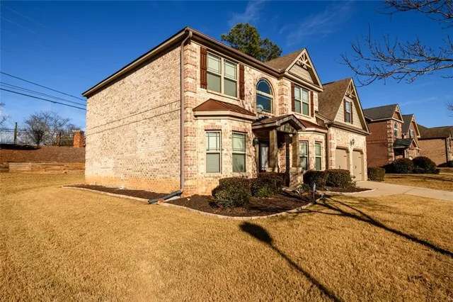 a front view of a house with a yard