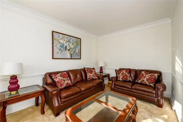 a living room with furniture a couch and a dining table with wooden floor