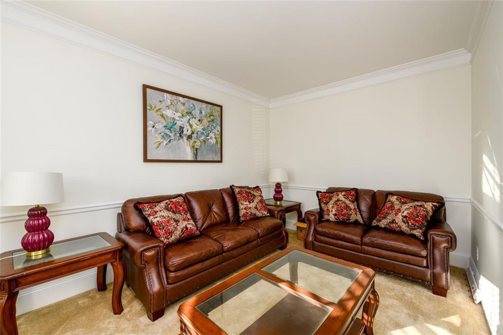 1979 Trinity Mill Drive Dacula, GA 30019 - Photo 7 of 38 a living room with furniture a couch and a dining table with wooden floor
