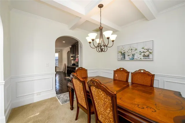 a view of a dining room with furniture and chandelier