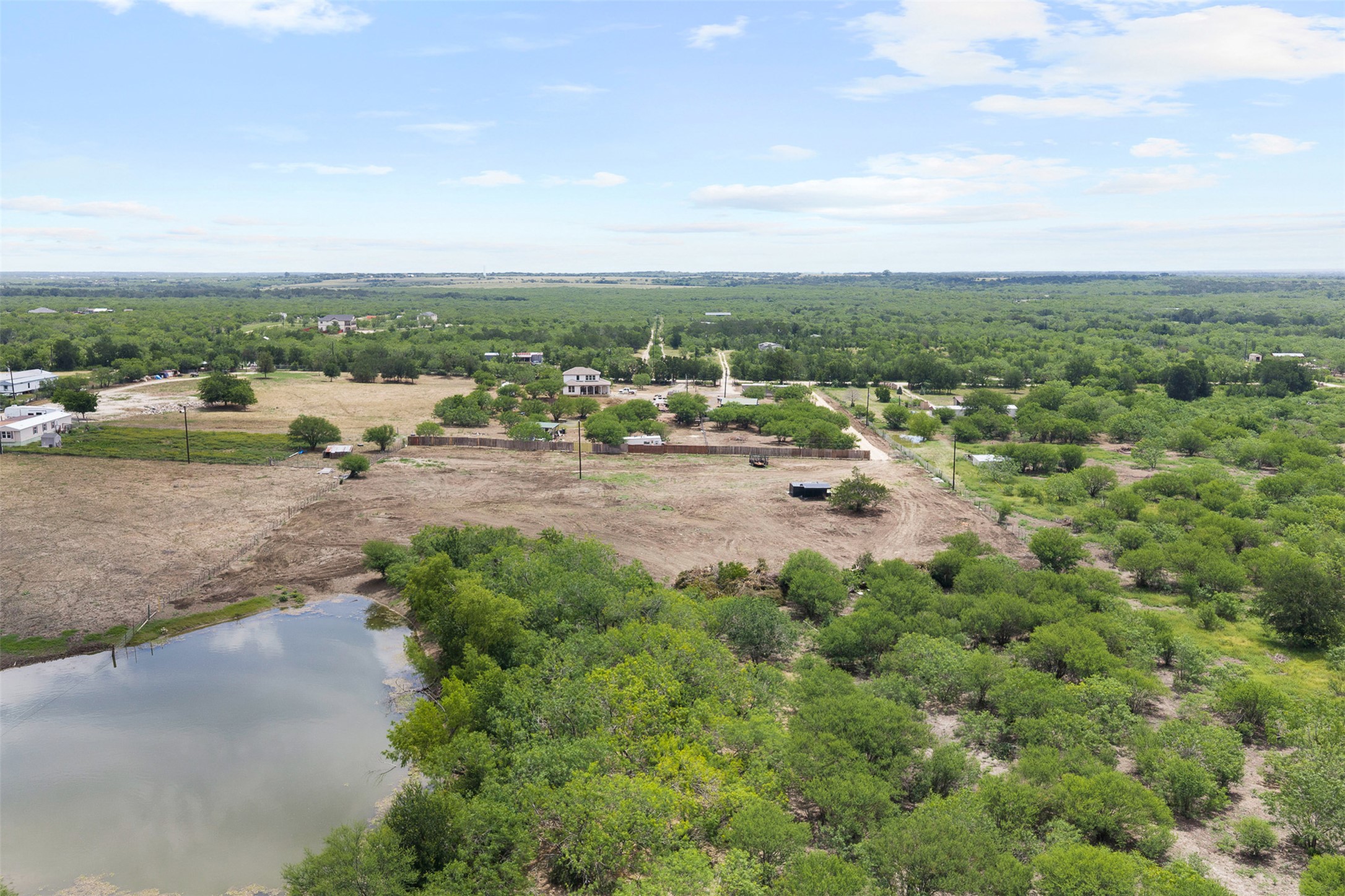 3315 Dry Creek Road Lockhart, TX 78644 - Photo 3 of 26 Vast natural landscape with scattered homes and a serene pond offers abundant privacy.