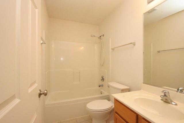 216 Longview Drive Elgin, IL 60124 - Photo 15 of 20 a bathroom with a sink a toilet and shower