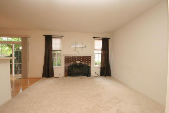 216 Longview Drive Elgin, IL 60124 - Photo 2 of 20 a view of an empty room with a fireplace