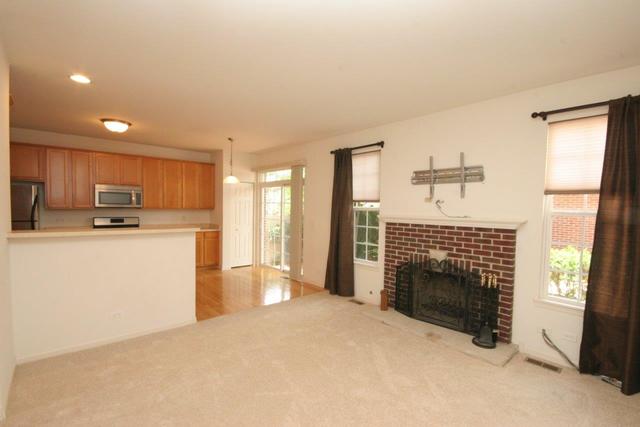 216 Longview Drive Elgin, IL 60124 - Photo 3 of 20 a kitchen with refrigerator a stove and a window