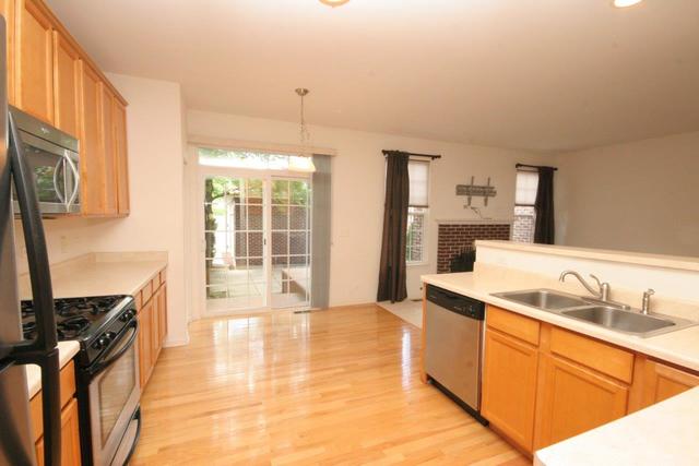 216 Longview Drive Elgin, IL 60124 - Photo 7 of 20 a kitchen with stainless steel appliances granite countertop a sink stove and refrigerator
