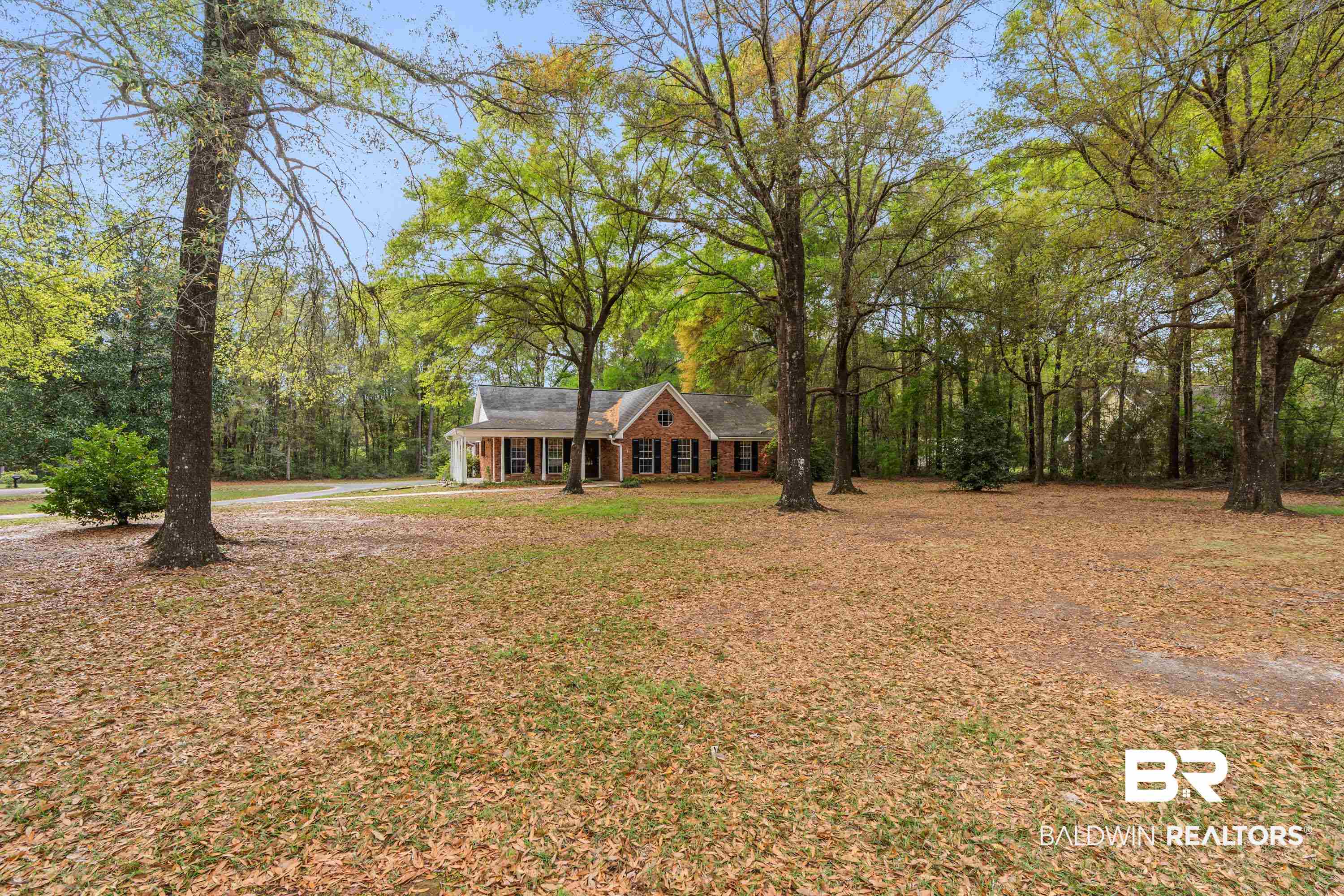 10140 Lakeview Road Bay Minette, AL 36507 - Photo 26 of 35 View of grassy yard featuring covered porch and view of scattered trees