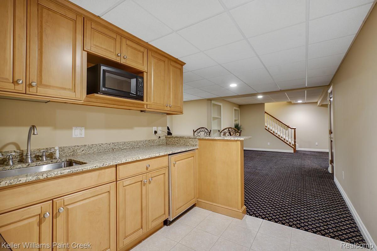 4902 Crestone Way Rochester, MI 48306 - Photo 60 of 70 Full Kitchenette/Wet Bar with counter seating.