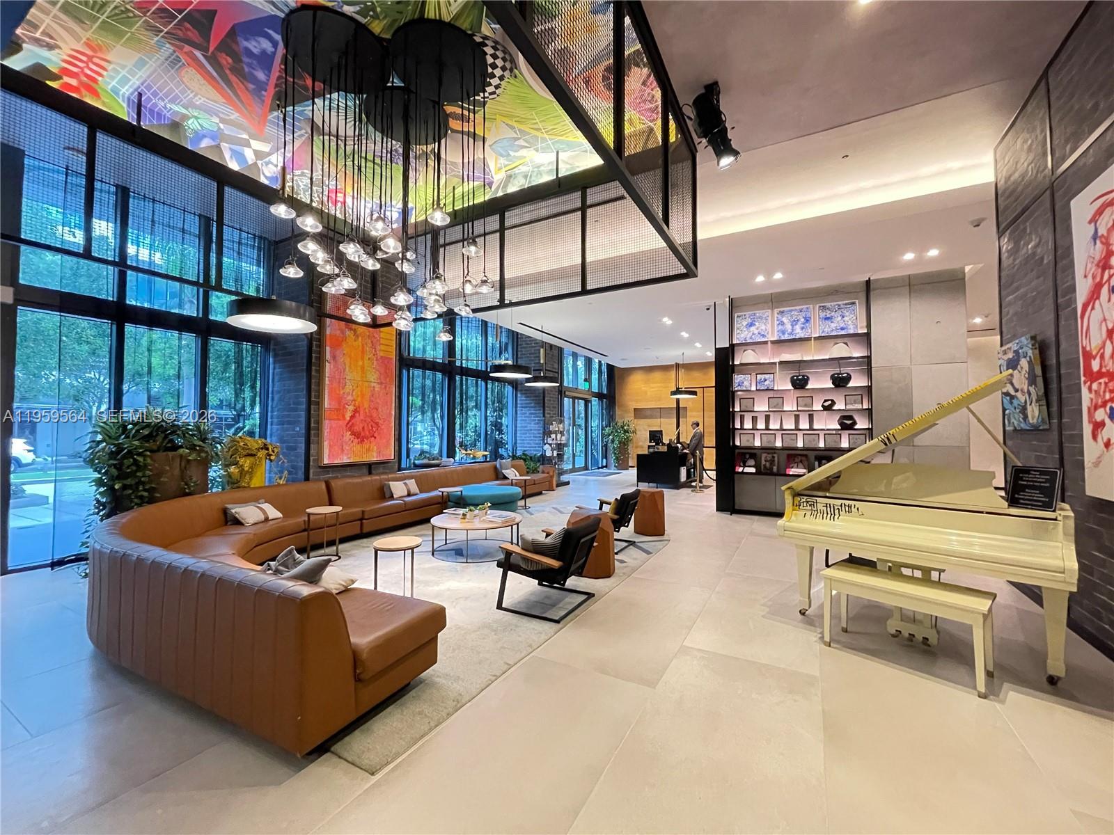 121 Northeast 34th Street, Unit L401 Miami, FL 33137 - Photo 2 of 37 a building outdoor space with patio furniture