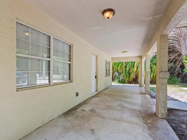 a view of a livingroom with wooden floor and a window