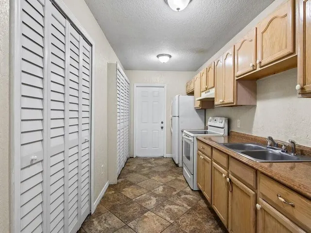 a kitchen with a sink and cabinets