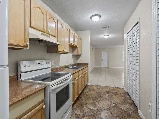 a kitchen with stainless steel appliances granite countertop a stove and a sink