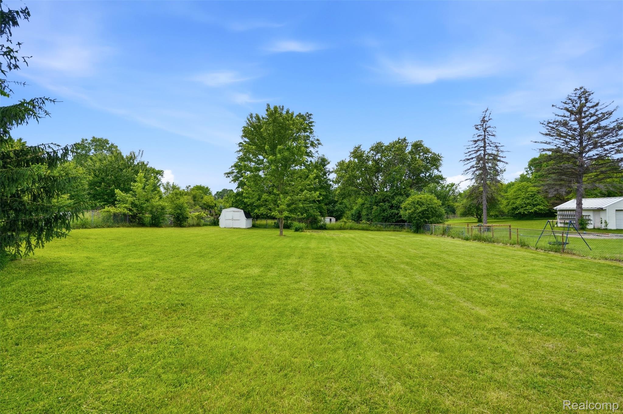 4420 Dublin Road Burton, MI 48529 - Photo 41 of 56 Expansive green lawn with mature perimeter trees