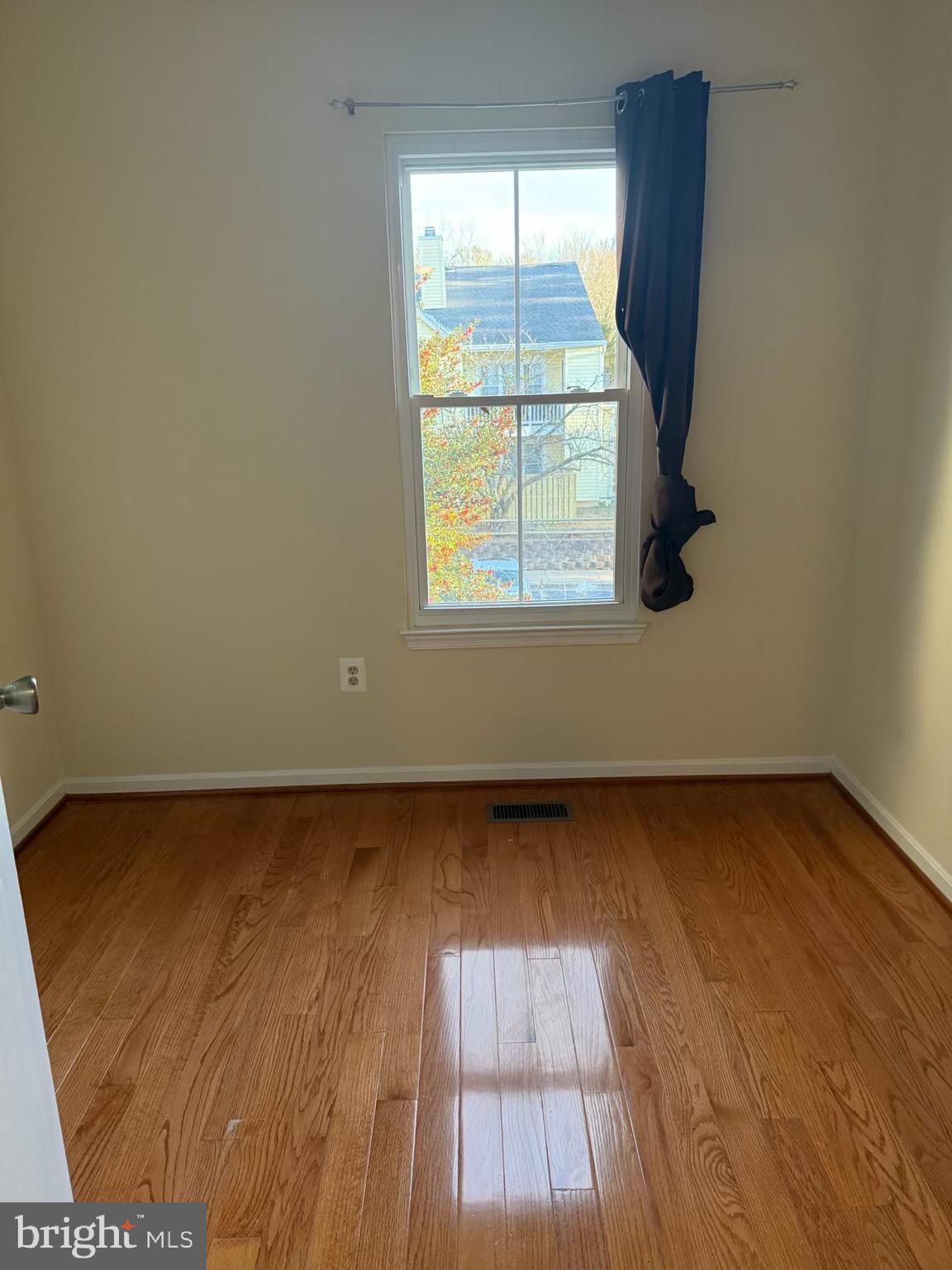 18272 Rolling Meadow Way Olney, MD 20832 - Photo 16 of 21 an empty room with wooden floor and windows
