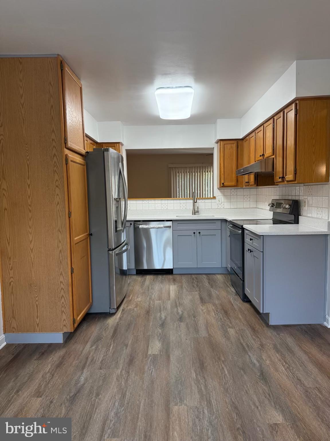 18272 Rolling Meadow Way Olney, MD 20832 - Photo 2 of 21 a kitchen with wooden floors and stainless steel appliances