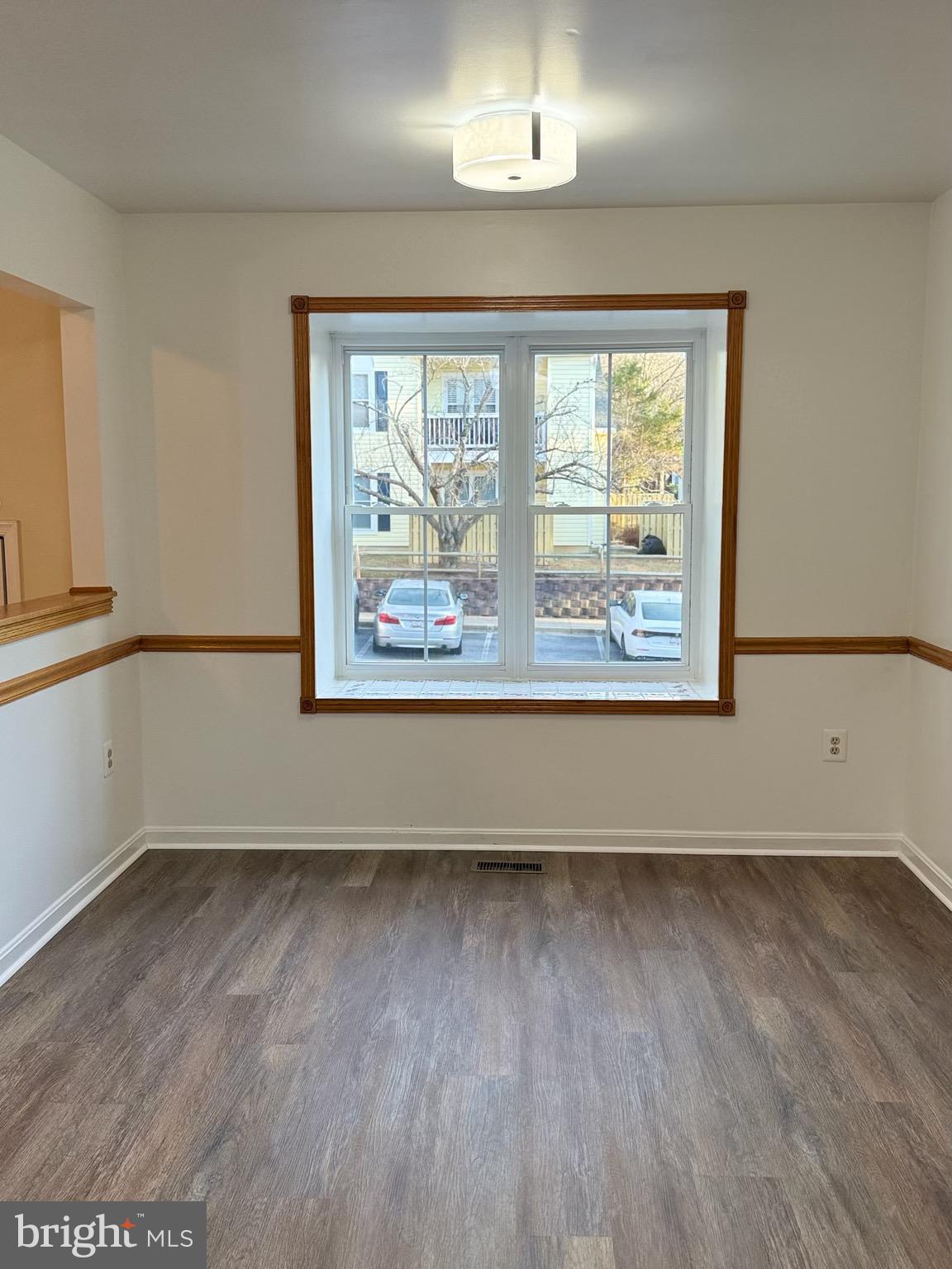 18272 Rolling Meadow Way Olney, MD 20832 - Photo 6 of 21 an empty room with wooden floor and windows
