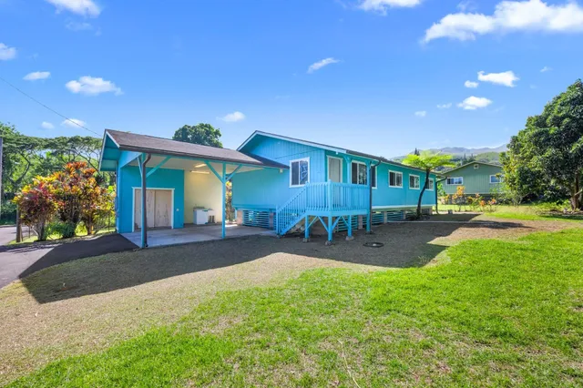 a view of a house with backyard porch and sitting area