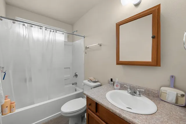 an aerial view of multi story residential apartment building with yard