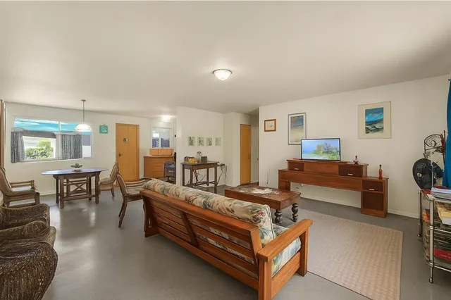 a living room with furniture and a dining table