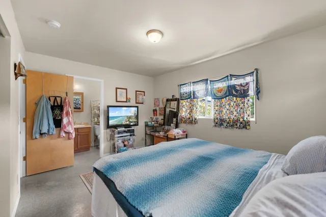 a bedroom with a bed and window