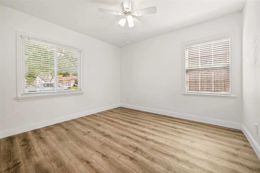 2316 Cunningham Street Irving, TX 75062 - Photo 15 of 22 Bright room featuring wood-finish flooring, white walls, and a ceiling fan