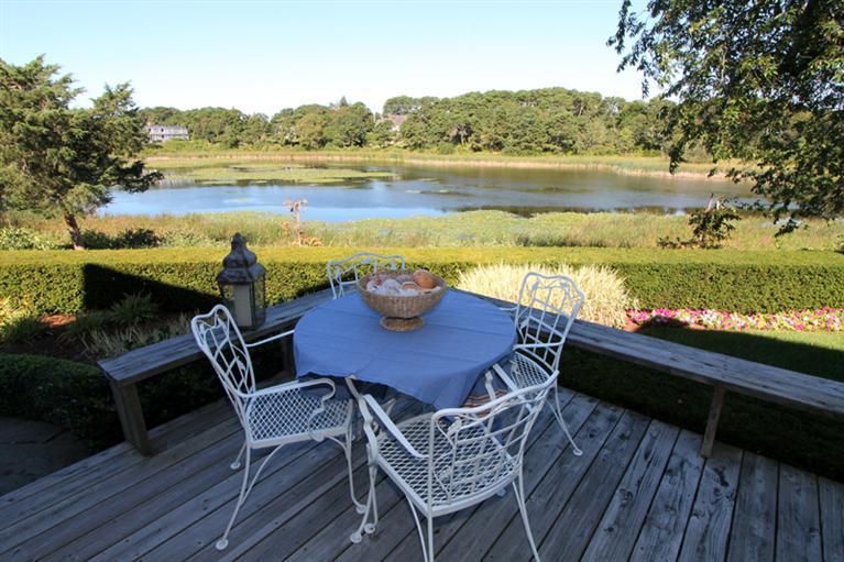 123 Strong Island Road Chatham, MA 02633 - Photo 23 of 34 a view of a chairs and table on wooden deck with lake view