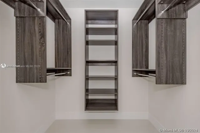 a view of walk in closet with empty racks
