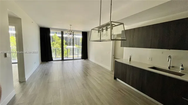 a view of hallway with wooden floor and windows