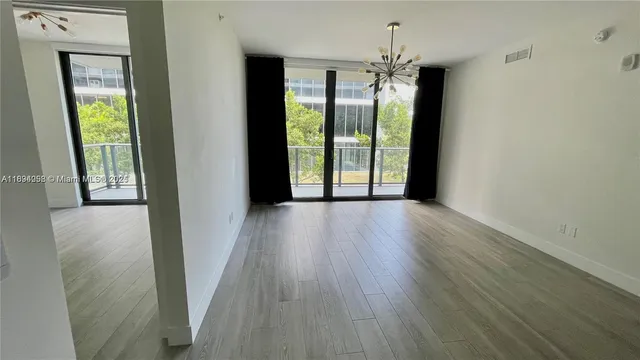 a view of livingroom with front door and wooden floor