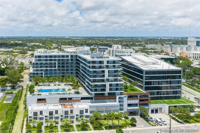 an aerial view of building with yard