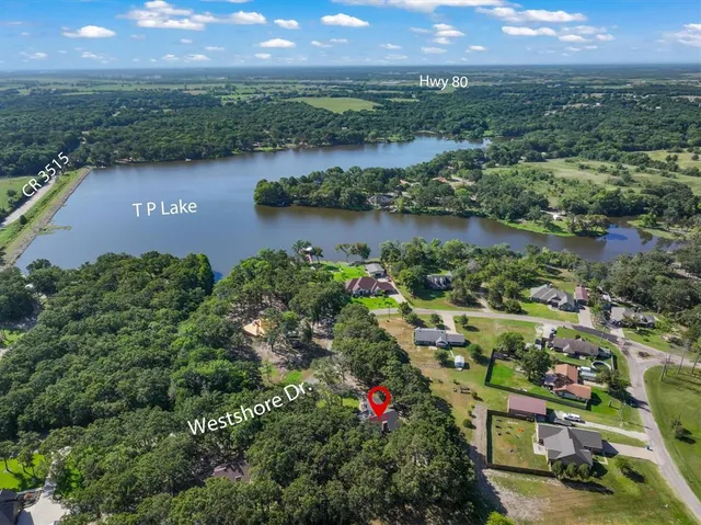 an aerial view of lake and residential houses with outdoor space
