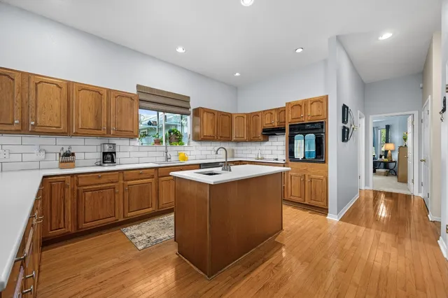 a large kitchen with stainless steel appliances granite countertop a stove and a sink