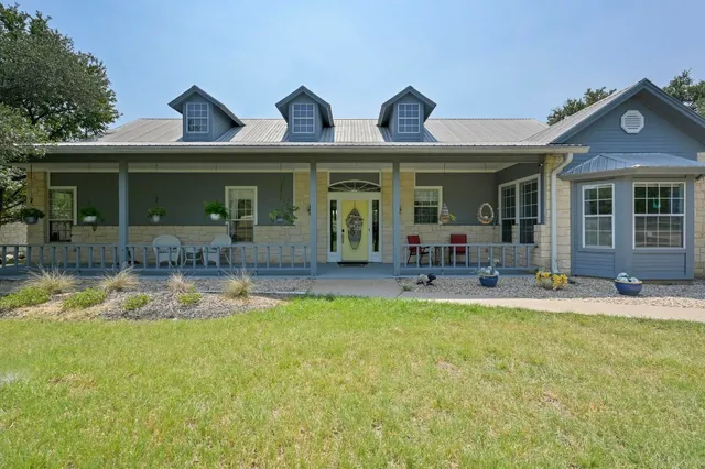 a view of a house with swimming pool and furniture